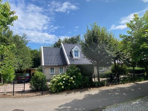 a house on the side of a street at Vrijstaande villa met grote tuin, 4 slaapkamers en sauna in Zeewolde