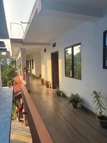 a balcony of a house with potted plants on it at The Bodhgaya Guest House in Bodh Gaya
