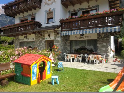 a play house in the yard of a house at Hotel al Sole in Auronzo di Cadore