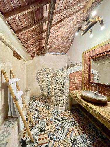 a bathroom with a sink and a mirror at Puri Samana Villas by Tanya Pink in Uluwatu