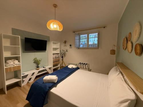 a bedroom with a large bed and a tv at Sea and Sand's Ville HOWME in Bari