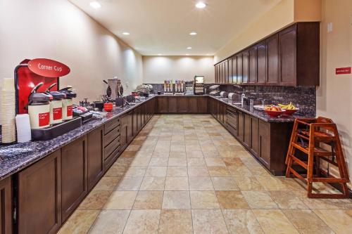a large kitchen with wooden counter tops in a restaurant at TownePlace Suites by Marriott Odessa in Odessa