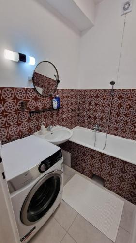a washing machine in a bathroom with a sink at Apartment Justina in Staré Mesto
