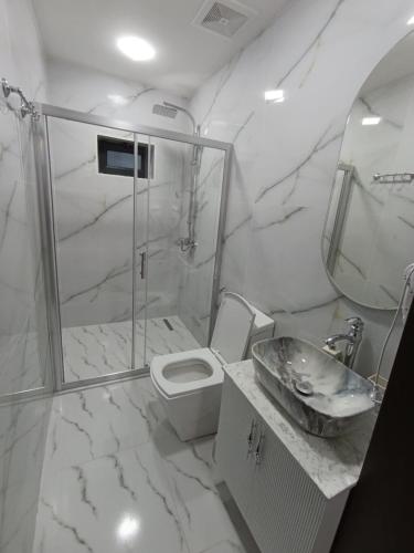 a bathroom with a shower and a toilet and a sink at A Frame Houses in Sheki