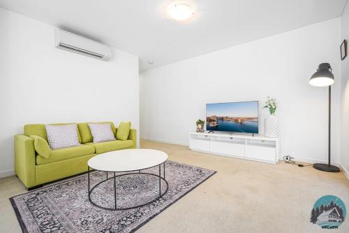 a living room with a yellow couch and a table at Aircabin - Gordon - Modern - 2 Beds Apt Free Park in Gordon