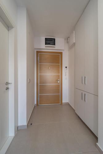 a hallway with a wooden door in a building at Vozdove Kapije Belgrade Apartment Studio in Voždovac