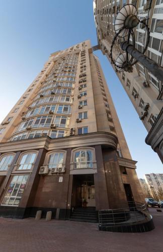 a tall building with stairs in front of a building at Apartment Obolon Natalka Park in Kyiv
