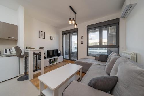 a living room with a couch and a table at Vozdove Kapije Belgrade Apartment Studio in Voždovac