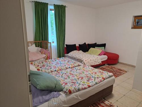 two beds in a room with green curtains at Appartement Julis 1 in 3430 Tulln in Tulln