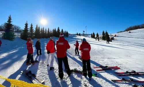 a group of people standing in the snow at Pataklak Mátra in Matrakeresztes