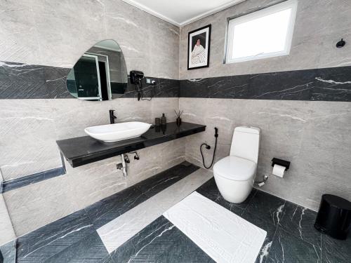 a bathroom with a sink and a toilet at Airport Green Olive Villa in Katunayaka