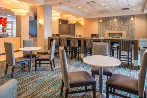 a lobby with tables and chairs and a bar at Residence Inn Pittsburgh North Shore in Pittsburgh