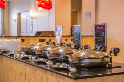 a row of four pots on a stove in a kitchen at Residence Inn Pittsburgh North Shore in Pittsburgh