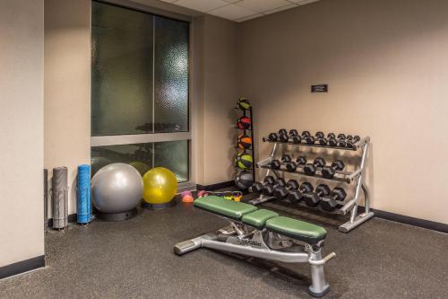 a room with a gym with a bench and weights at Residence Inn Pittsburgh North Shore in Pittsburgh