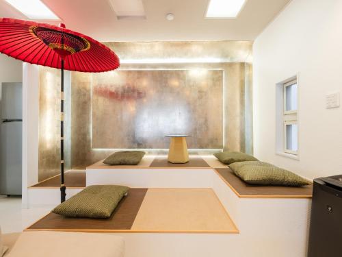 a room with two benches with a red umbrella at Shinjuku 2min 140 Square meters VR Switch Photo Booth pc in Tokyo