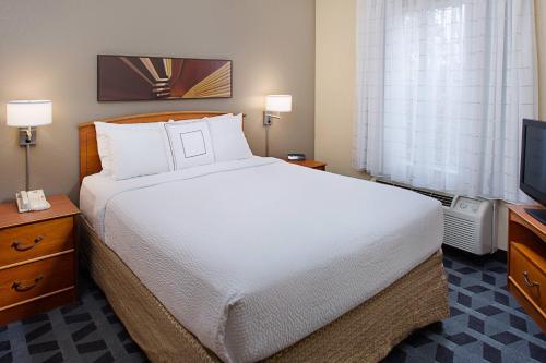 a bedroom with a large bed and a television at TownePlace Suites Philadelphia Horsham in Horsham