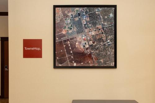 a picture hanging on a wall in a museum at TownePlace Suites by Marriott Midland in Midland