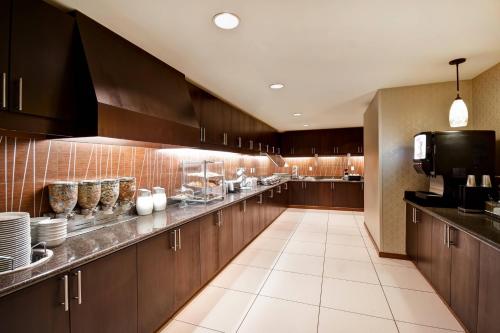 a large kitchen with wooden cabinets and a counter top at Residence Inn by Marriott Stillwater in Stillwater