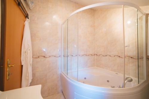 a bathroom with a shower and a bath tub at Apartment Aldo in Omiš