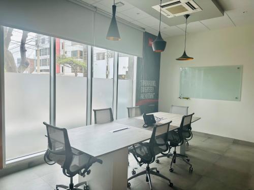 a meeting room with a table and chairs in an office at ibis Trujillo in Trujillo