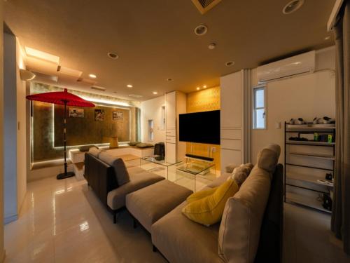 a living room with a large couch and a red umbrella at Shinjuku 2min 140 Square meters VR Switch Photo Booth pc in Tokyo