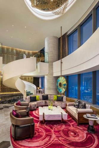 a living room with couches and a red rug at W Suzhou - Jinji Lake in Suzhou