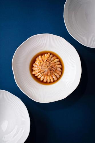 a white plate with a cup of coffee on it at W Suzhou - Jinji Lake in Suzhou