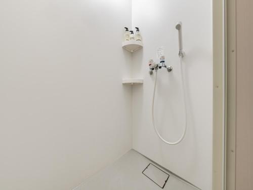 a shower in a white bathroom with a sink at Shinjuku 2min 140 Square meters VR Switch Photo Booth pc in Tokyo