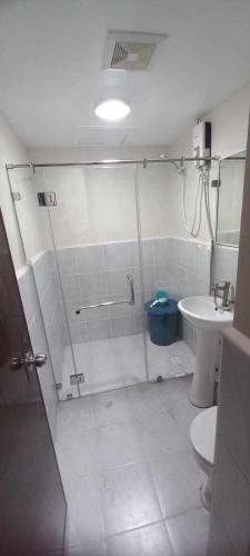 a bathroom with a shower and a toilet and a sink at 1 bedroom condominium in Lapu2x in Lapu Lapu City