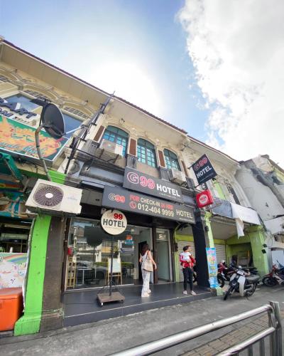 a building with people standing in front of it at G99 Hotel in George Town