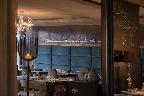 a dining room with tables and chairs and a chalkboard at Atrium Hotel Mainz in Mainz