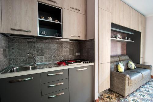 a kitchen with a sink and a stove top oven at Casa Buonaiuto in Castellabate