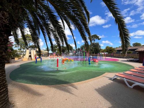 a group of people playing in a water park at Mobil home sur le bassin d'Arcachon in Lège-Cap-Ferret