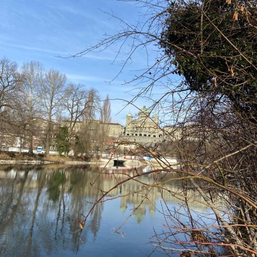 a bridge over a river with a building in the background at Naturnahe Familienwohnung in Rüschegg-Graben