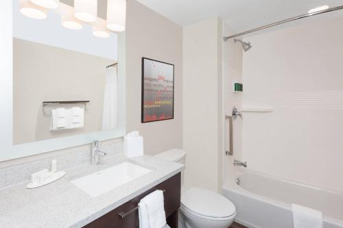 a white bathroom with a sink and a toilet at TownePlace Suites by Marriott Titusville Kennedy Space Center in Titusville