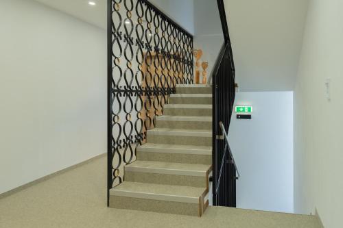 a staircase in a building with a black gate at RIMA Apart‘s in Heiterwang