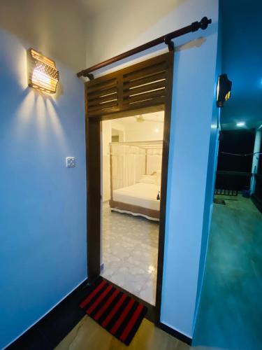 a door to a bedroom with a bed in a room at Lake View Villa - Tangalle in Tangalle