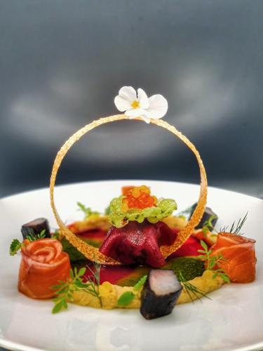 a plate of food with a flower on top at Le PasSionNant in Morzine