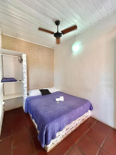 a bedroom with a bed and a ceiling fan at Nova Aldeia Buzios in Búzios