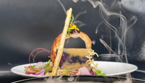 a plate of food with a sandwich on it at Le PasSionNant in Morzine