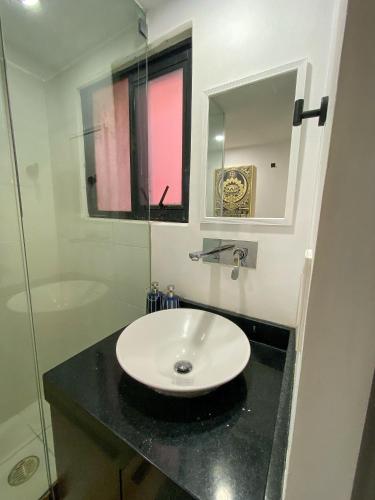 a bathroom with a white sink and a mirror at Cozy Flat Condesa in Mexico City