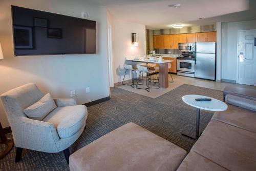 a living room with a couch and a kitchen at Residence Inn by Marriott Pensacola Downtown in Pensacola