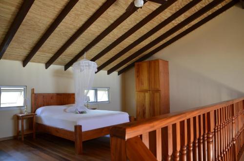 a bedroom with a bed and a wooden staircase at Kaye Coco in Soufri&egrave;re