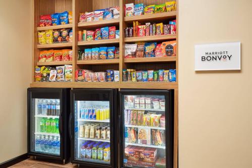 a store with two refrigerators and shelves of food at TownePlace Suites by Marriott Leesburg in Leesburg