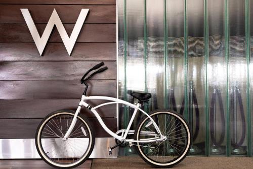 a white bike parked next to aww sign on a wall at W Scottsdale in Scottsdale