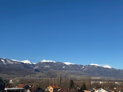 a city with snow covered mountains in the background at Hotel Majestic in Struga