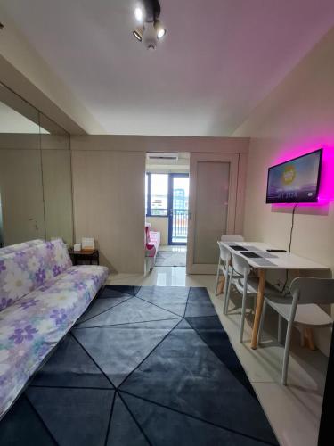 a living room with a couch and a table at King of kings at SEA RESIDENCES in Manila