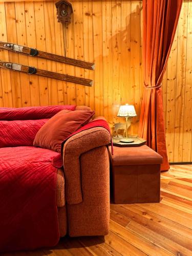 a bedroom with a bed and a table with a lamp at Casetta sul Lago di Misurina in Misurina