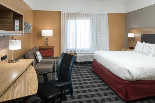 a hotel room with a bed and a desk at TownePlace Suites by Marriott Panama City in Panama City
