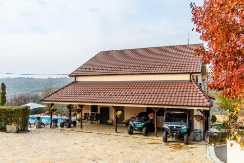 a house with two motorcycles parked in front of it at Alrawda Resort in Risti°i